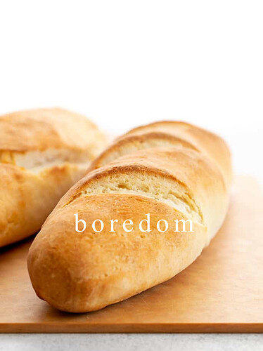 Two-loaves-of-French-bread-on-a-cutting-board