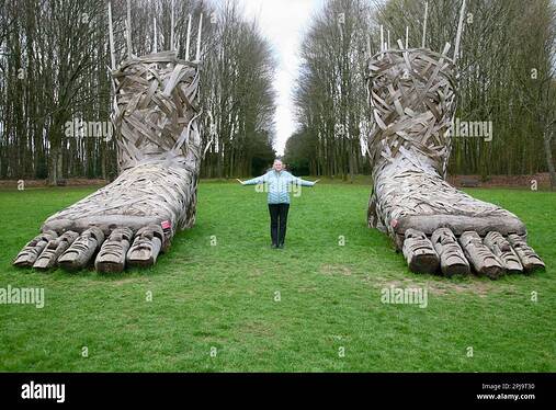 a-lady-positioned-between-two-large-feet-at-the-chateau-de-flers-normandy-france-europe-2PJ9T30-2684532105