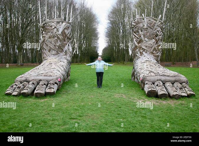 a-lady-positioned-between-two-large-feet-at-the-chateau-de-flers-normandy-france-europe-2PJ9T30-2684532105